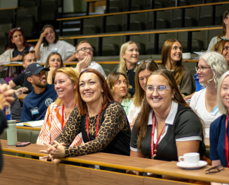A group of apprentices and LHU staff sat in a lecture theatre, smiling and engaged with the presentation